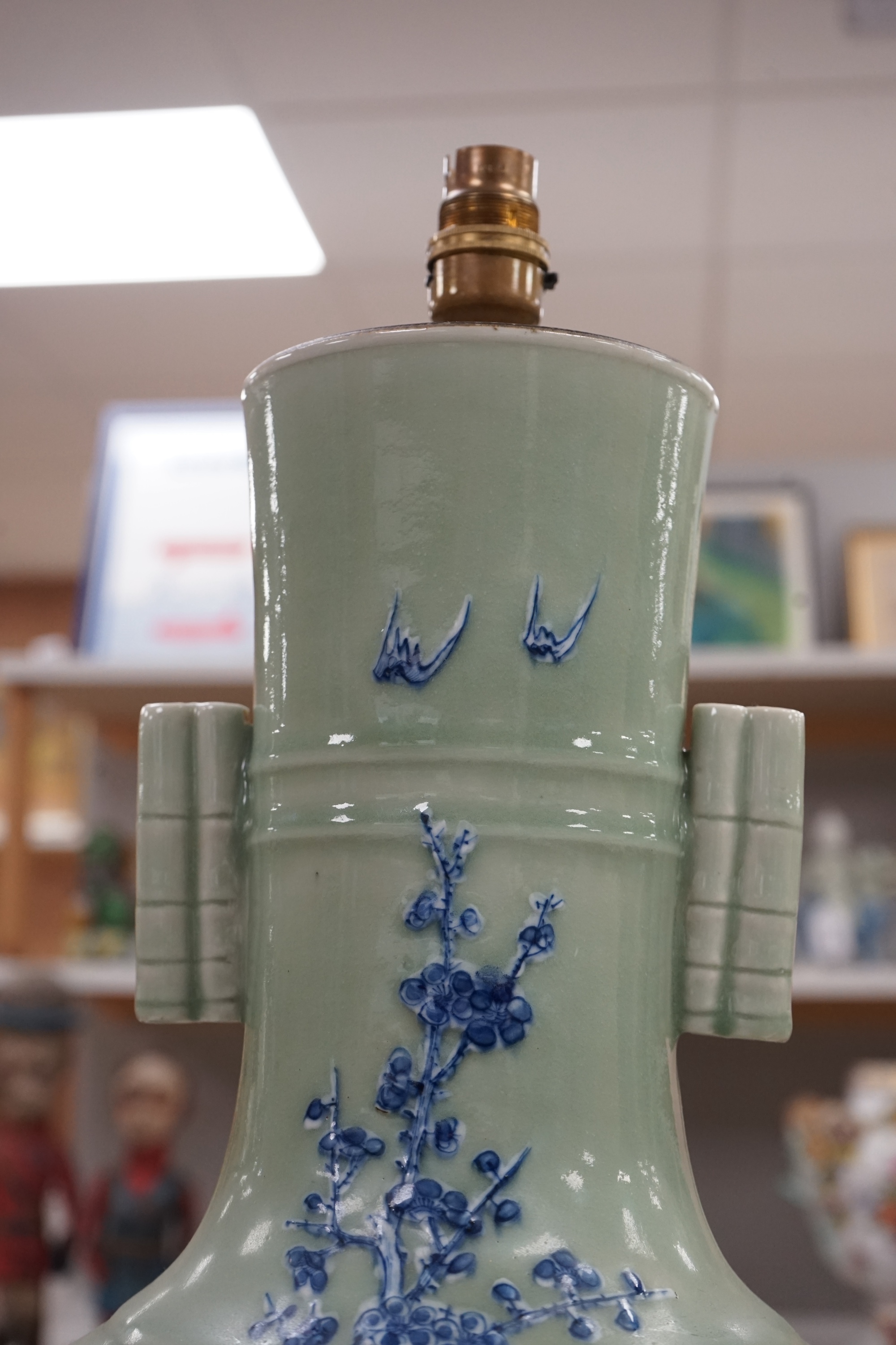 A large Chinese underglaze blue and slip decorated celadon ground vase, converted to a lamp, 61cm high. Condition - a crack 16cm down the side of the body